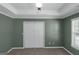 Bedroom with closet featuring bi-fold doors, ceiling fan and ample natural light from a large window at 5003 Samantha Ct, Mcdonough, GA 30252