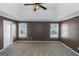 Bedroom with carpet floors and a tray ceiling is enhanced by two windows providing natural light at 5003 Samantha Ct, Mcdonough, GA 30252