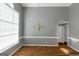 Open dining room featuring hardwood floors, large windows, and a chandelier at 5003 Samantha Ct, Mcdonough, GA 30252