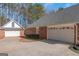 Brick home featuring a two-car garage, separate garage, and a well-maintained yard and driveway at 5003 Samantha Ct, Mcdonough, GA 30252