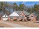 Well-maintained brick home with a clean lawn, attached garage, and classic architectural design at 5003 Samantha Ct, Mcdonough, GA 30252
