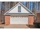 Spacious detached garage featuring a clean white door and a complementary brick and siding exterior at 5003 Samantha Ct, Mcdonough, GA 30252