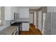 Modern kitchen with stainless steel appliances, granite countertops, white cabinets, and hardwood flooring at 5003 Samantha Ct, Mcdonough, GA 30252