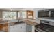 Well-equipped kitchen with granite countertops, stainless steel appliances, white cabinetry, and a view of a water feature at 5003 Samantha Ct, Mcdonough, GA 30252