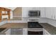 Kitchen area featuring stainless steel appliances, granite countertops, white subway tile backsplash, and white cabinetry at 5003 Samantha Ct, Mcdonough, GA 30252