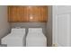 A convenient laundry room with a washer and dryer hookup and storage cabinets at 5003 Samantha Ct, Mcdonough, GA 30252