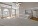 Open-concept living space with neutral carpet, hardwood, and granite-topped bar connecting to a kitchen with white cabinetry at 5003 Samantha Ct, Mcdonough, GA 30252