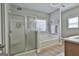 Bright bathroom with a glass shower, soaking tub, tile accents, and a large window for natural light at 35 Ryans Ct, Sharpsburg, GA 30277