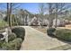 Long driveway leading to a white home with meticulous landscaping and mature trees at 35 Ryans Ct, Sharpsburg, GA 30277