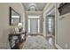 Welcoming foyer with hardwood floors, elegant console table and a bright white front door with sidelights at 35 Ryans Ct, Sharpsburg, GA 30277