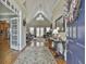 Grand foyer with vaulted ceilings, hardwood floors, elegant console table and doorway to a spacious living area at 35 Ryans Ct, Sharpsburg, GA 30277