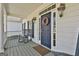 Charming front entrance featuring a blue door, decorative wreath and wall lanterns, complemented by a welcoming door mat at 35 Ryans Ct, Sharpsburg, GA 30277
