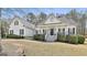 Charming white two-story home with a welcoming front porch and manicured landscaping at 35 Ryans Ct, Sharpsburg, GA 30277