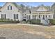 Charming white two-story home with a welcoming front porch and manicured landscaping at 35 Ryans Ct, Sharpsburg, GA 30277