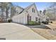 Detached garage with long driveway and complementary architecture to the main house at 35 Ryans Ct, Sharpsburg, GA 30277