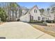 Detached garage with long driveway and complementary architecture to the main house at 35 Ryans Ct, Sharpsburg, GA 30277