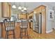 Spacious kitchen featuring stainless steel appliances, a breakfast bar, and wooden cabinets at 35 Ryans Ct, Sharpsburg, GA 30277