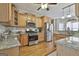 Modern kitchen featuring wooden cabinets, granite countertops, and stainless steel appliances at 35 Ryans Ct, Sharpsburg, GA 30277