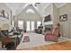 Spacious living room with vaulted ceilings, stone fireplace, neutral carpet, and comfortable seating at 35 Ryans Ct, Sharpsburg, GA 30277
