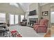 Spacious living room with vaulted ceilings, stone fireplace, neutral carpet, and comfortable seating at 35 Ryans Ct, Sharpsburg, GA 30277