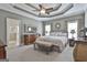 Spacious main bedroom with a coffered ceiling, neutral decor, bench seating, and ensuite bathroom access at 35 Ryans Ct, Sharpsburg, GA 30277