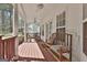 Beautiful outdoor porch with a wooden bench, rocking chairs, and ceiling fans at 35 Ryans Ct, Sharpsburg, GA 30277