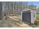 Backyard shed featuring a large door and ramp for easy access and additional storage space at 35 Ryans Ct, Sharpsburg, GA 30277