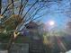 A neglected home exterior with a boarded front door, visible damage, and an overgrown yard needing significant restoration at 950 Joseph E Boone Nw Blvd, Atlanta, GA 30314