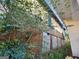 Exterior shot showing a brick foundation and siding, partly obscured by overgrown bushes at 950 Joseph E Boone Nw Blvd, Atlanta, GA 30314