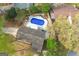 Stunning aerial view of a private backyard oasis with sparkling pool, manicured landscaping, and patio area at 205 Raintree Bnd, Peachtree City, GA 30269