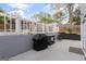 Flat backyard features a built-in grill, stone terracing, and seating for four at 205 Raintree Bnd, Peachtree City, GA 30269