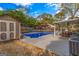 Large flat backyard features a pool, shed, pergola, seating, and privacy fence at 205 Raintree Bnd, Peachtree City, GA 30269