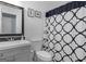 This bathroom has a shower/tub combo with a decorative shower curtain and a vanity sink at 205 Raintree Bnd, Peachtree City, GA 30269