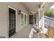 Inviting front porch features a hanging swing and a glimpse of the home's stone-accented entryway at 205 Raintree Bnd, Peachtree City, GA 30269