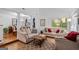 Bright, spacious living room showcases hardwood floors and neutral furniture next to the dining area at 205 Raintree Bnd, Peachtree City, GA 30269