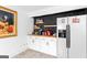 The bar area boasts white cabinets, a butcher block countertop, floating shelves, and a stainless steel refrigerator at 205 Raintree Bnd, Peachtree City, GA 30269