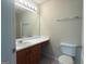Well-lit bathroom featuring a large mirror, single sink vanity and a tile floor at 661 Outlook Way, South Fulton, GA 30349