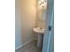 Elegant powder room with pedestal sink, modern fixtures, and stylish tile flooring at 661 Outlook Way, South Fulton, GA 30349