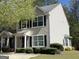 Charming two-story townhome with neutral siding, black shutters, and manicured landscaping at 661 Outlook Way, South Fulton, GA 30349