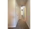 Neutral colored hallway with doors leading to carpeted bedrooms and bathrooms at 661 Outlook Way, South Fulton, GA 30349