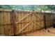 View of backyard with a brand new wooden fence featuring a gate with diagonal wooden beam support at 1475 Woodington Cir, Lawrenceville, GA 30044