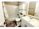 Bathroom with a tub-shower combo, vanity, and white fixtures at 1475 Woodington Cir, Lawrenceville, GA 30044