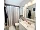 Well-lit bathroom with a shower-tub combo, vanity, and neutral color scheme at 1475 Woodington Cir, Lawrenceville, GA 30044