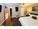 Bedroom featuring a queen-sized bed, side tables, hardwood floors, and neutral wall colors at 1475 Woodington Cir, Lawrenceville, GA 30044
