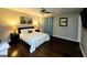 Bedroom with a queen-sized bed, side tables with lamps, and hardwood floors at 1475 Woodington Cir, Lawrenceville, GA 30044