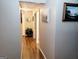 Hallway with wood flooring, neutral walls, and decorative artwork at 1475 Woodington Cir, Lawrenceville, GA 30044