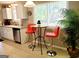 Charming eat-in kitchen featuring a breakfast bar and a garden view at 1475 Woodington Cir, Lawrenceville, GA 30044