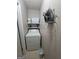 Functional laundry room with a washer, dryer, storage shelving, and a tile floor at 1475 Woodington Cir, Lawrenceville, GA 30044