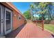 Exterior view of the stained wooden back deck and fenced backyard at 4691 Garden Hills Ct, Stone Mountain, GA 30083