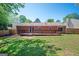 A spacious backyard features a wooden deck, lush grass, and a privacy fence at 4691 Garden Hills Ct, Stone Mountain, GA 30083